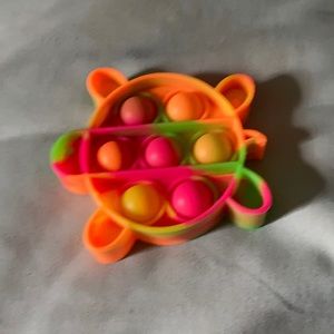 Turtle pop it.  Neon colors. Pink , green and orange